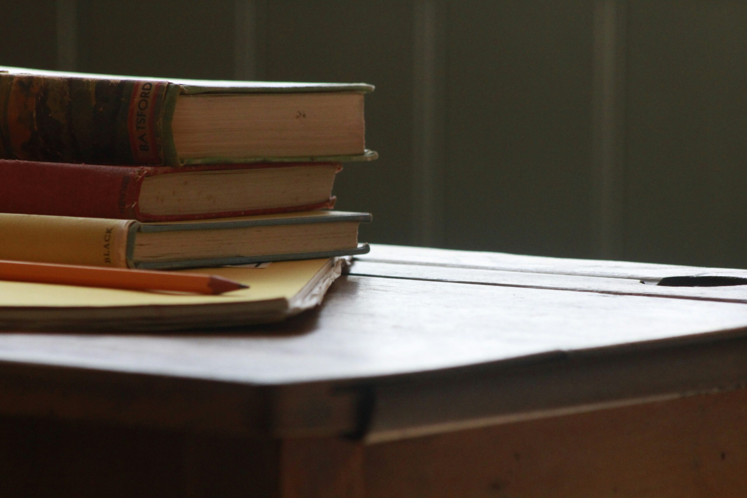 Stack of brand guideline books on a desk